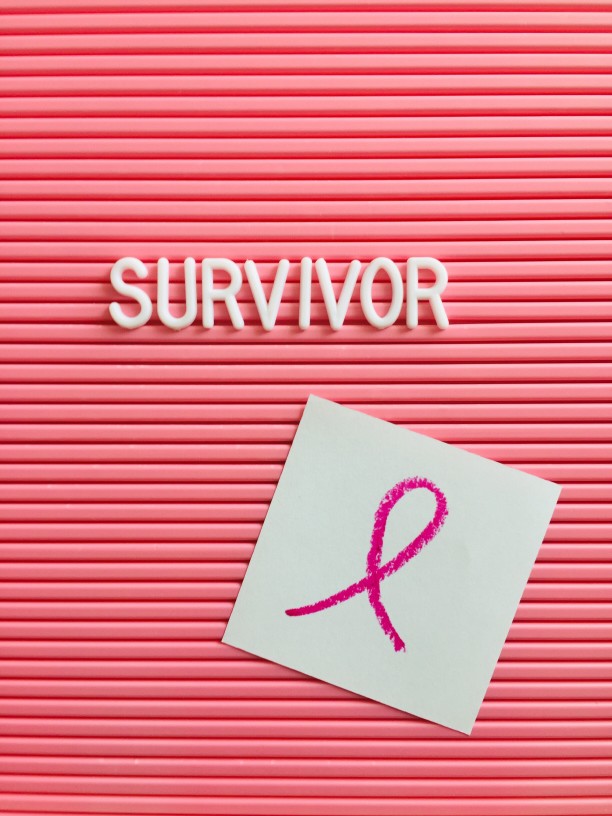 Pink board with the word survivor
