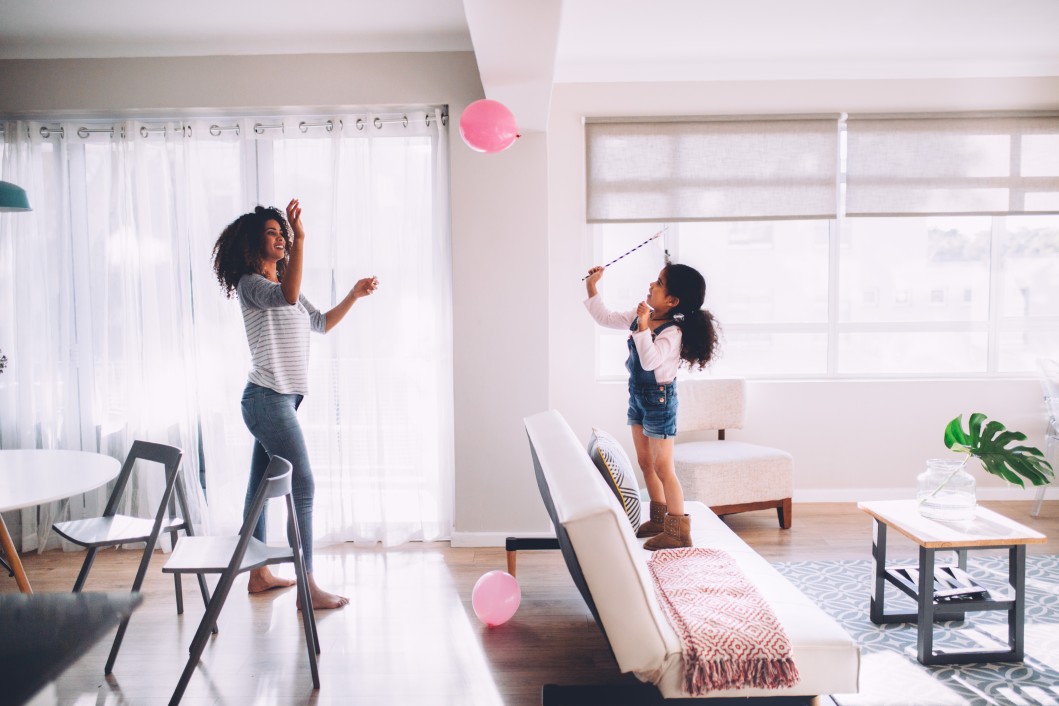 Mother and daughter playing with a balloon.