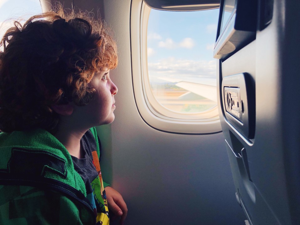 Child looking out plane window