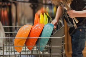 Child loading dishwasher