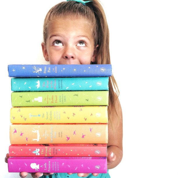 Child holding stack of books