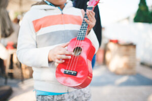 Child playing ukelele