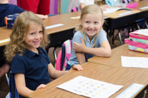 Two girls sitting in class