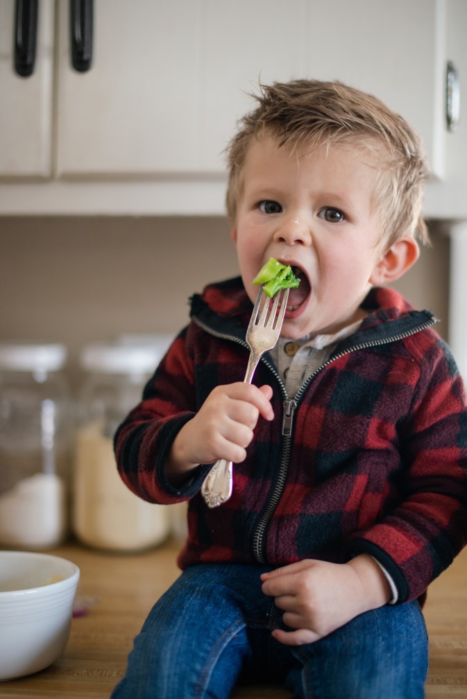 Child eating broccoli