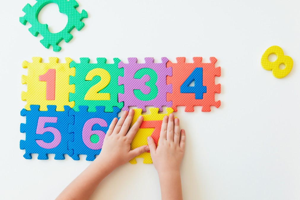 Child hands playing with puzzle