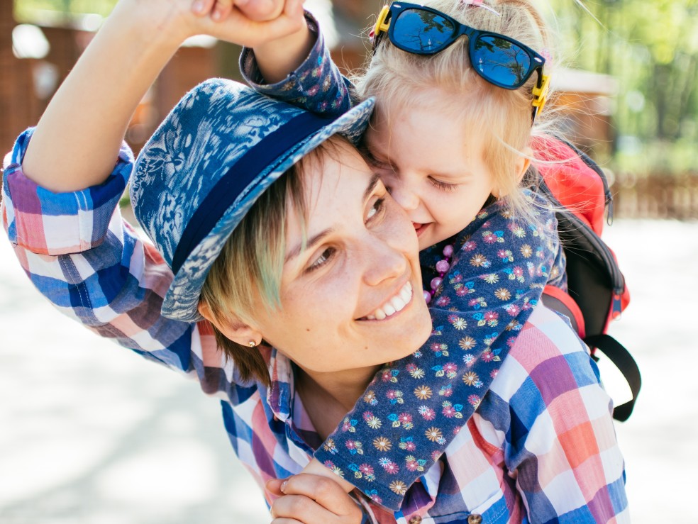 Mom holding child on shoulders