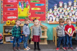 Preschoolers standing in a classroom