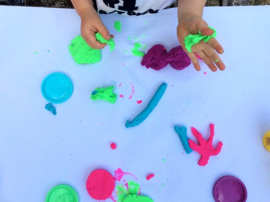 a-little-girl-hands-making-slime-herself-on-blue-wooden-background-slime- making-hand-children-toy_t20_rRaG0g - The Breakie Bunch Learning Center