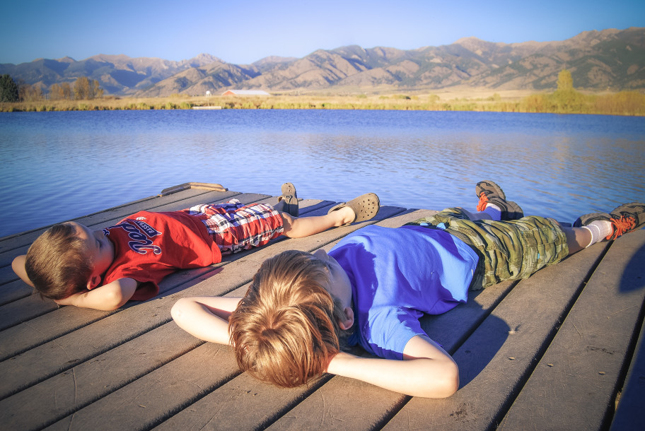 Kids laying on a dock