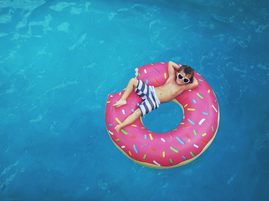 Kid laying in pool floatie