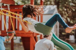 Little girl on a swing.