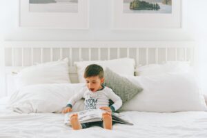 Child in bed reading