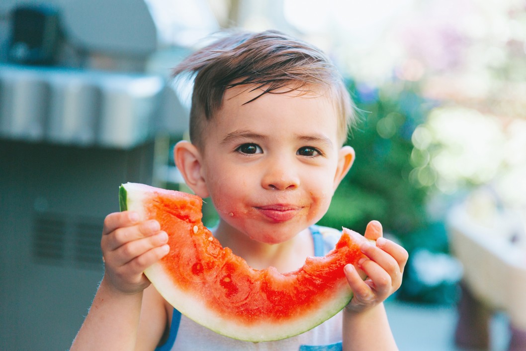 Toddler eating watermelon