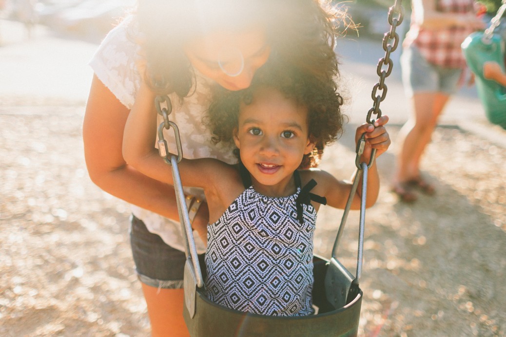 Toddler swinging at the park