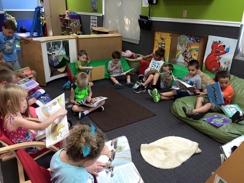 Preschoolers sitting together reading