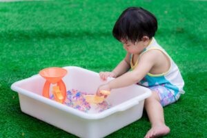 Child playing with water beads