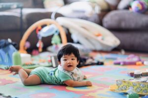 Baby practicing tummy time and smiling