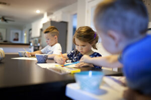 Kids painting at a table.