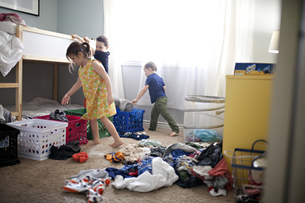 Kids doing laundry in their room.