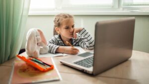 Little girl doing a worksheet at home.