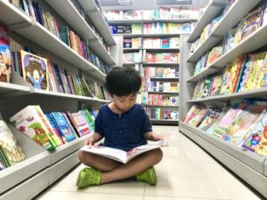 Child reading in a library.