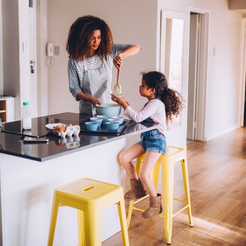 Mother cooking with her daughter.