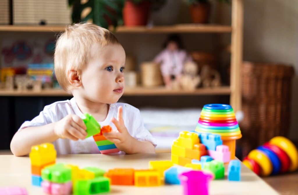 Infant playing with toys in a daycare.