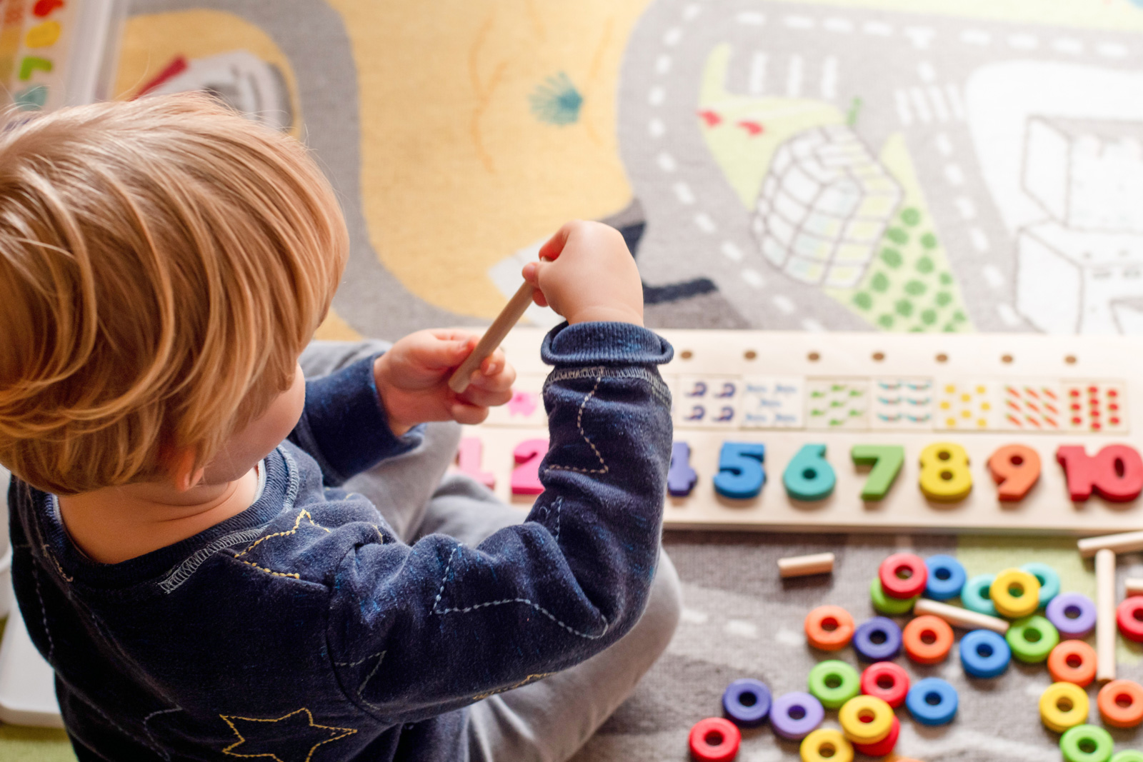 Child plays with puzzles in daycare setting