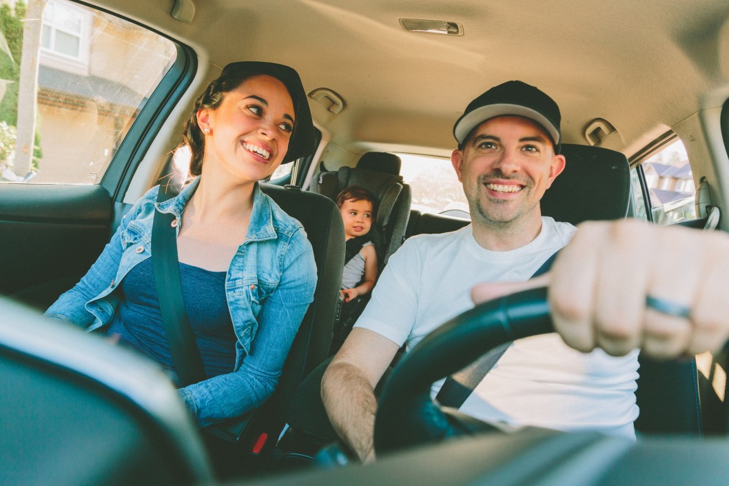 A family in a car going on a road trip.