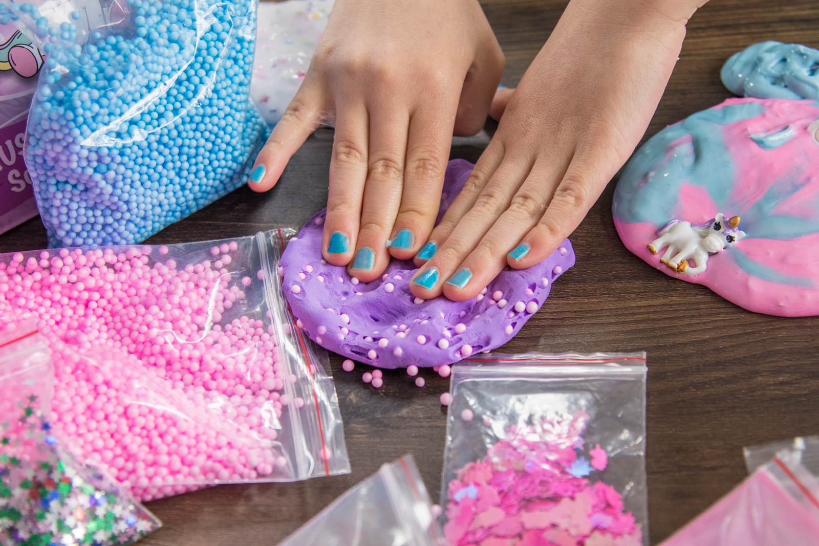 Child plays with Play Doh and adds mix-ins