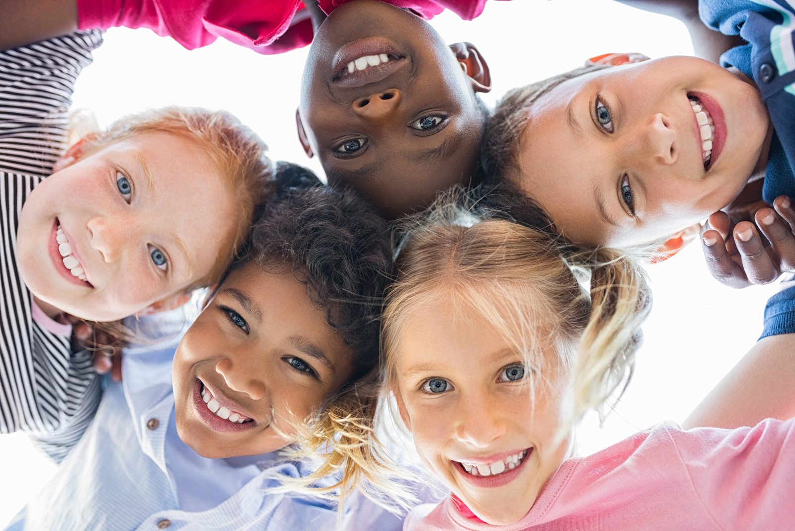 Group of pre-school friends with their heads together