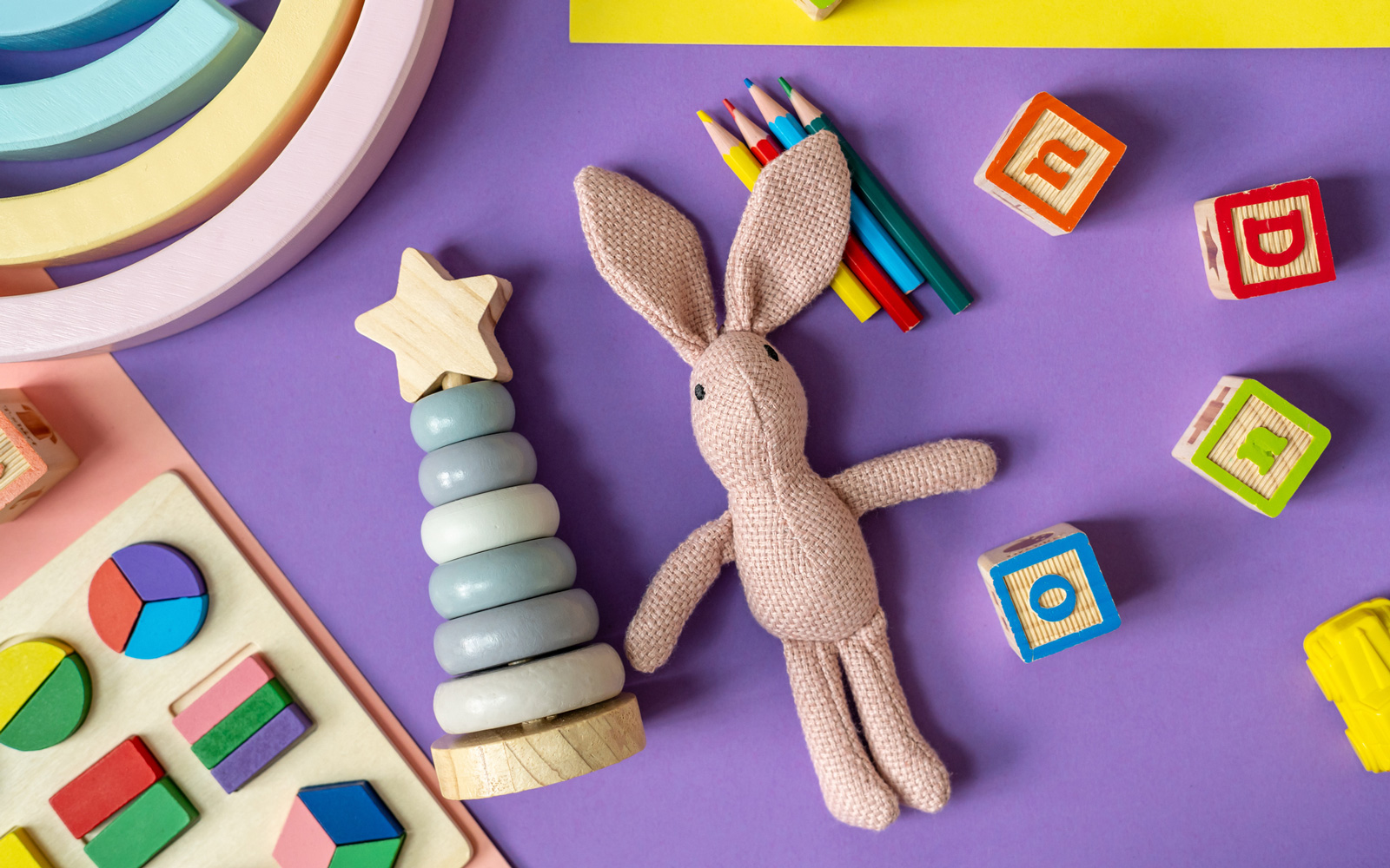 Toys and learning materials on purple background