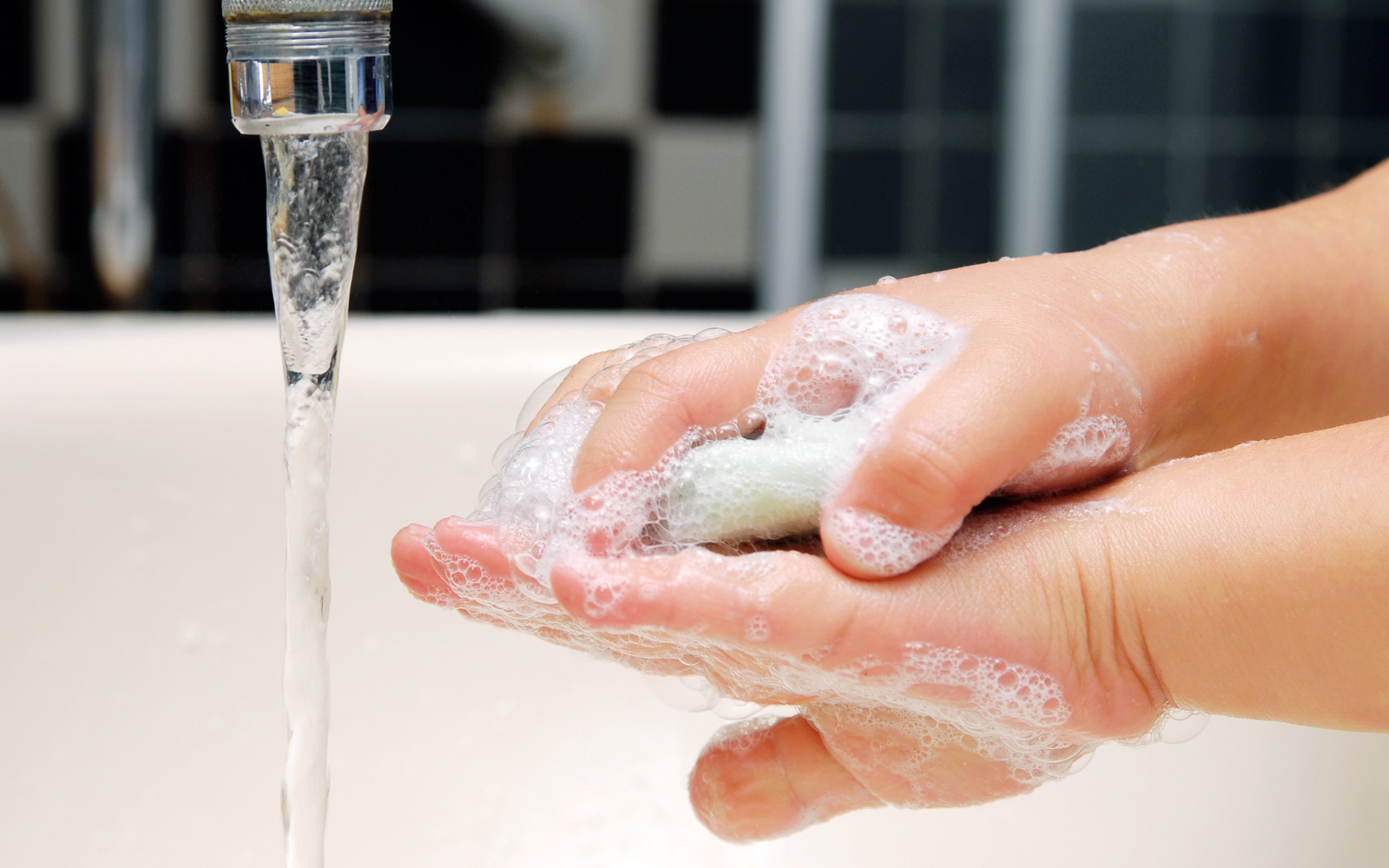 Toddler washes hands