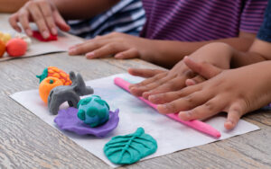 Kids work on fine motor skills with play doh