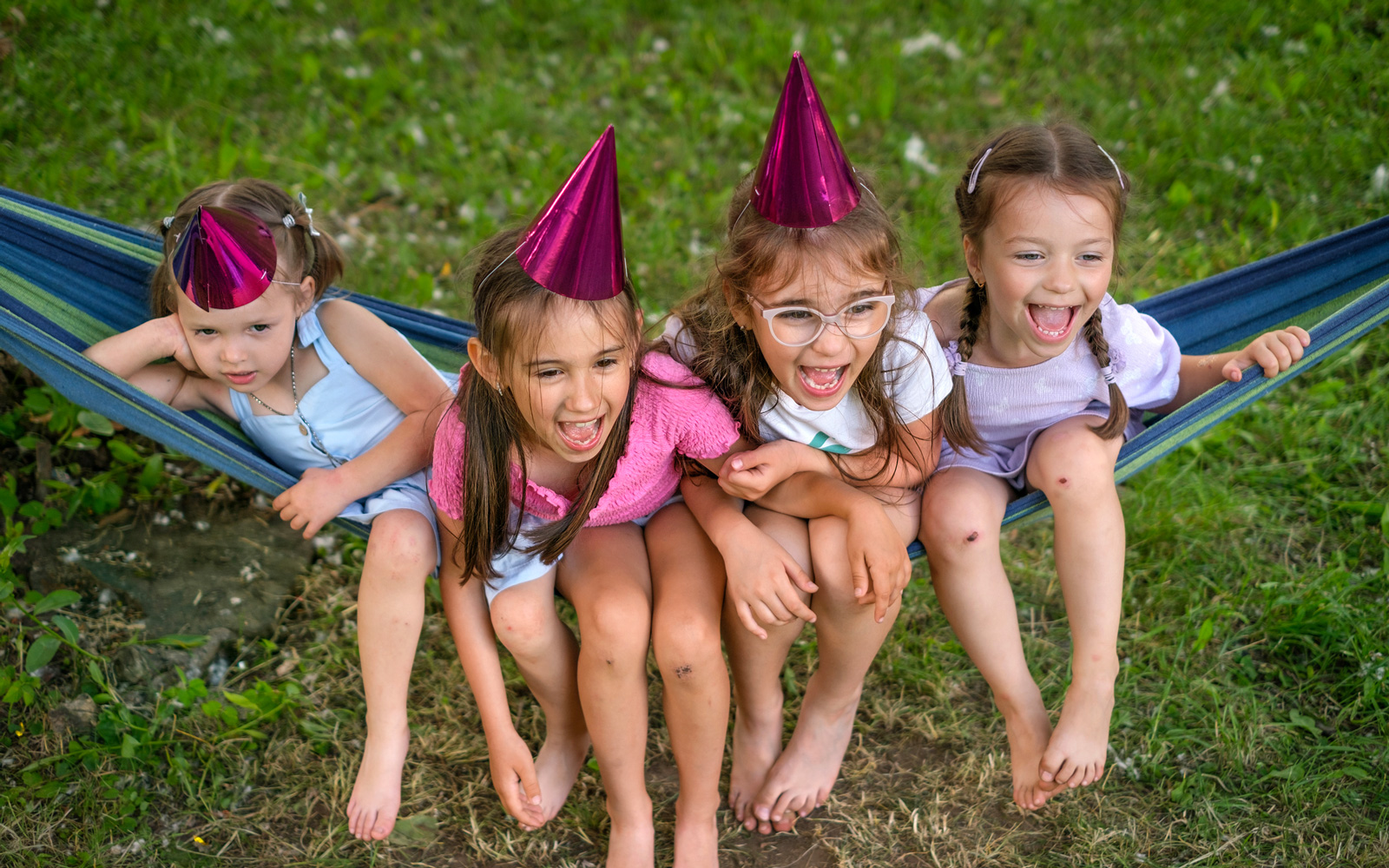 Kids sitting in a hammock at a birthday party