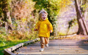 Toddler running on boardwalk