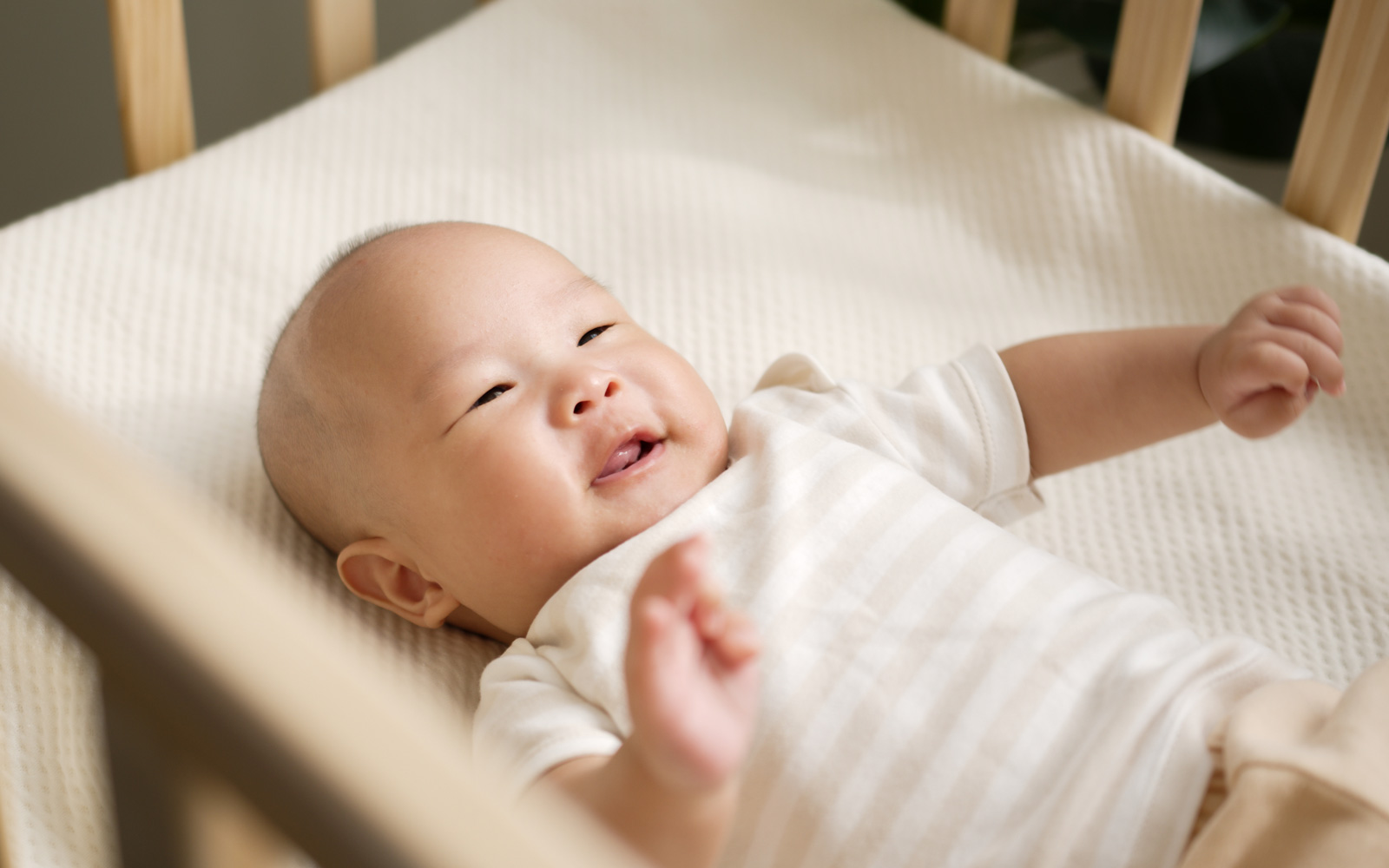 Infant laying in crib