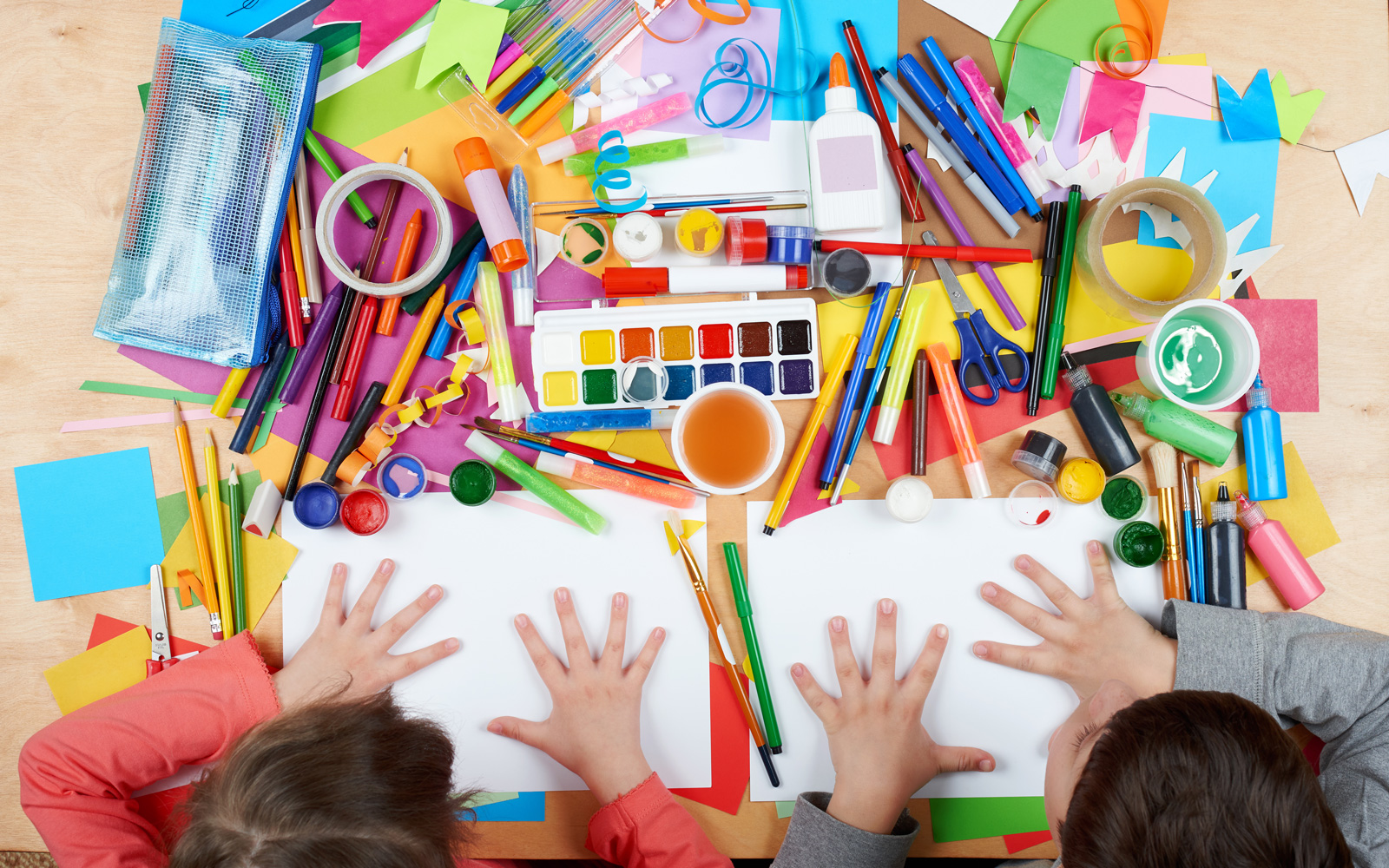 Overhead view of kids and art materials