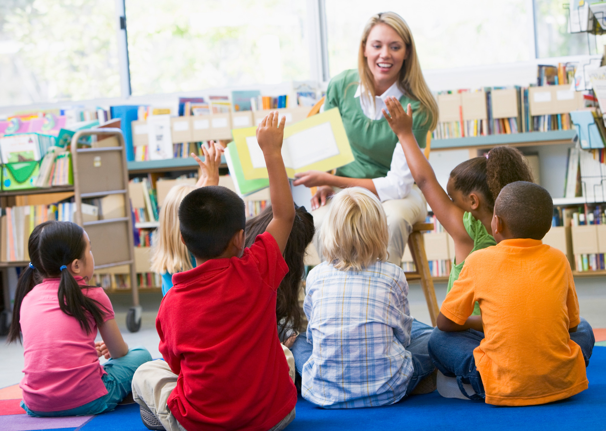 Childcare worker leads storytime in the classroom