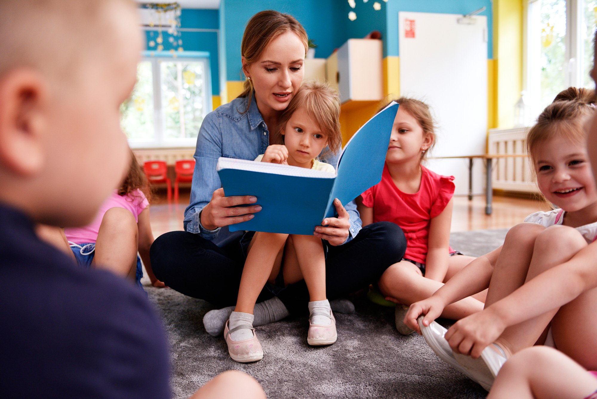 Daycare worker reads to children