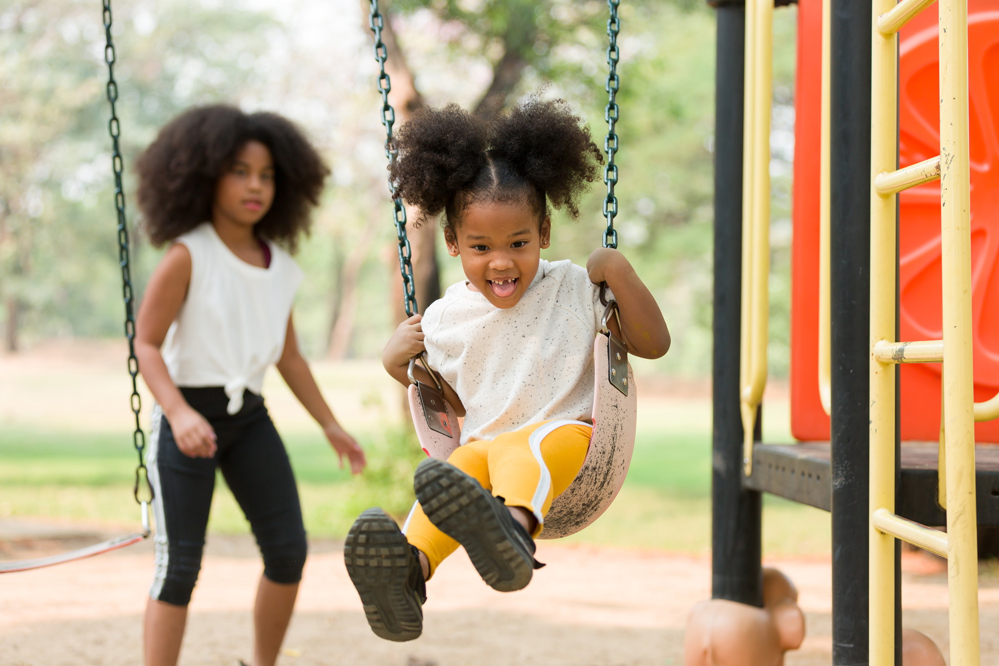 Children swing in the park