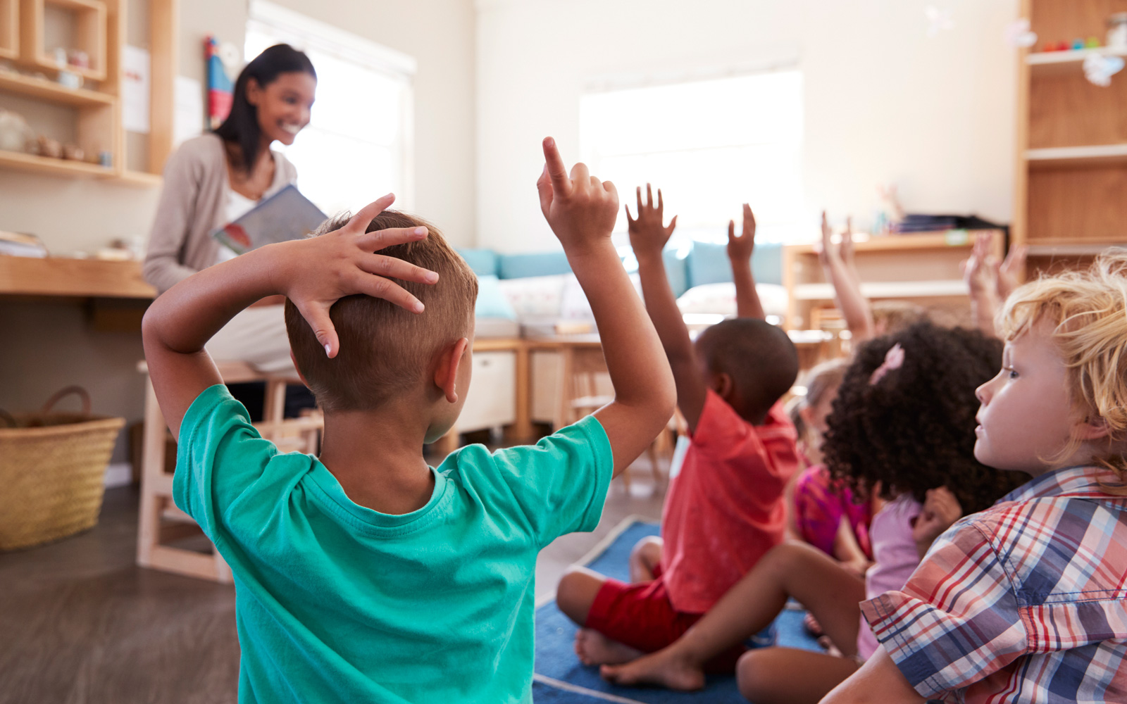 Children Raise Hands in Class