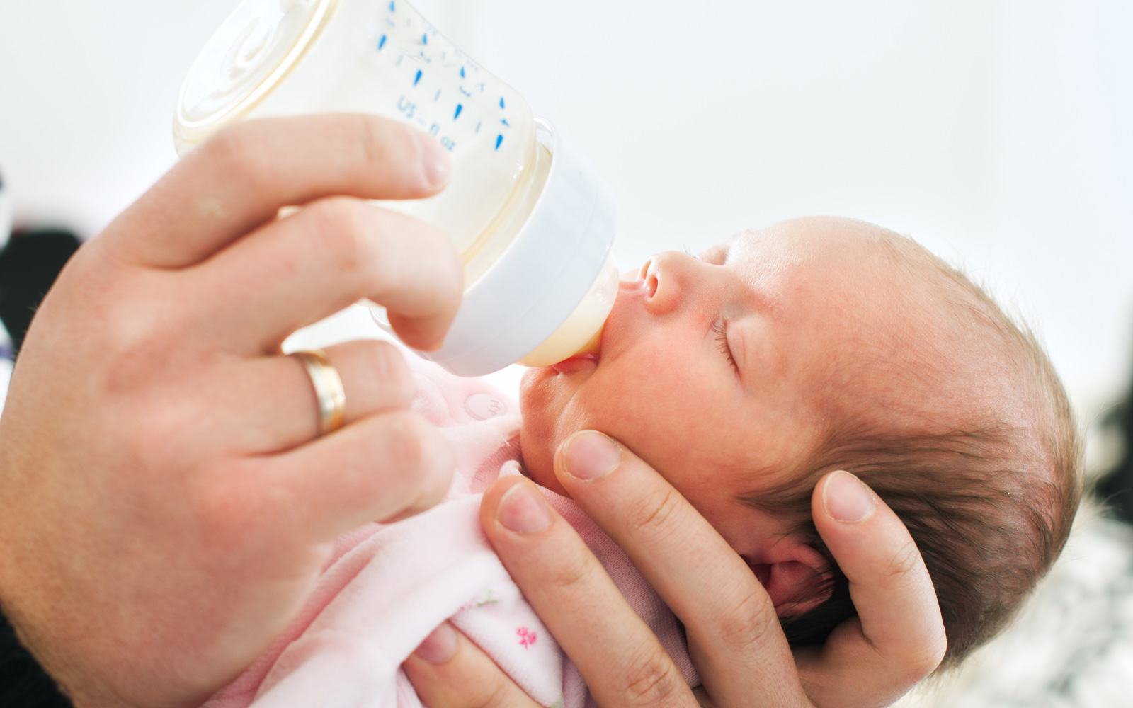 Person Feeding Baby a Bottle