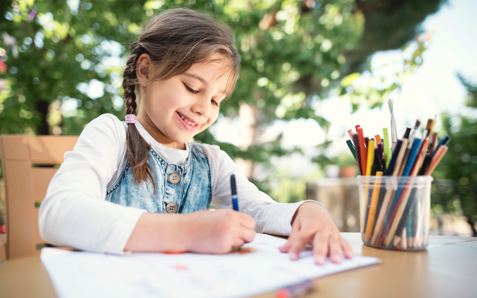 Child Draws with Colored Pencils