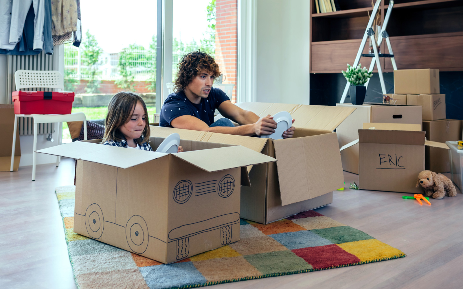 Father and Daughter Pretend Play with Moving Boxes