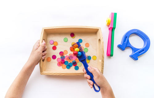 Toddle playing with sensory bin