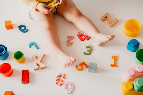 Toddler Plays with Letter and Number Blocks