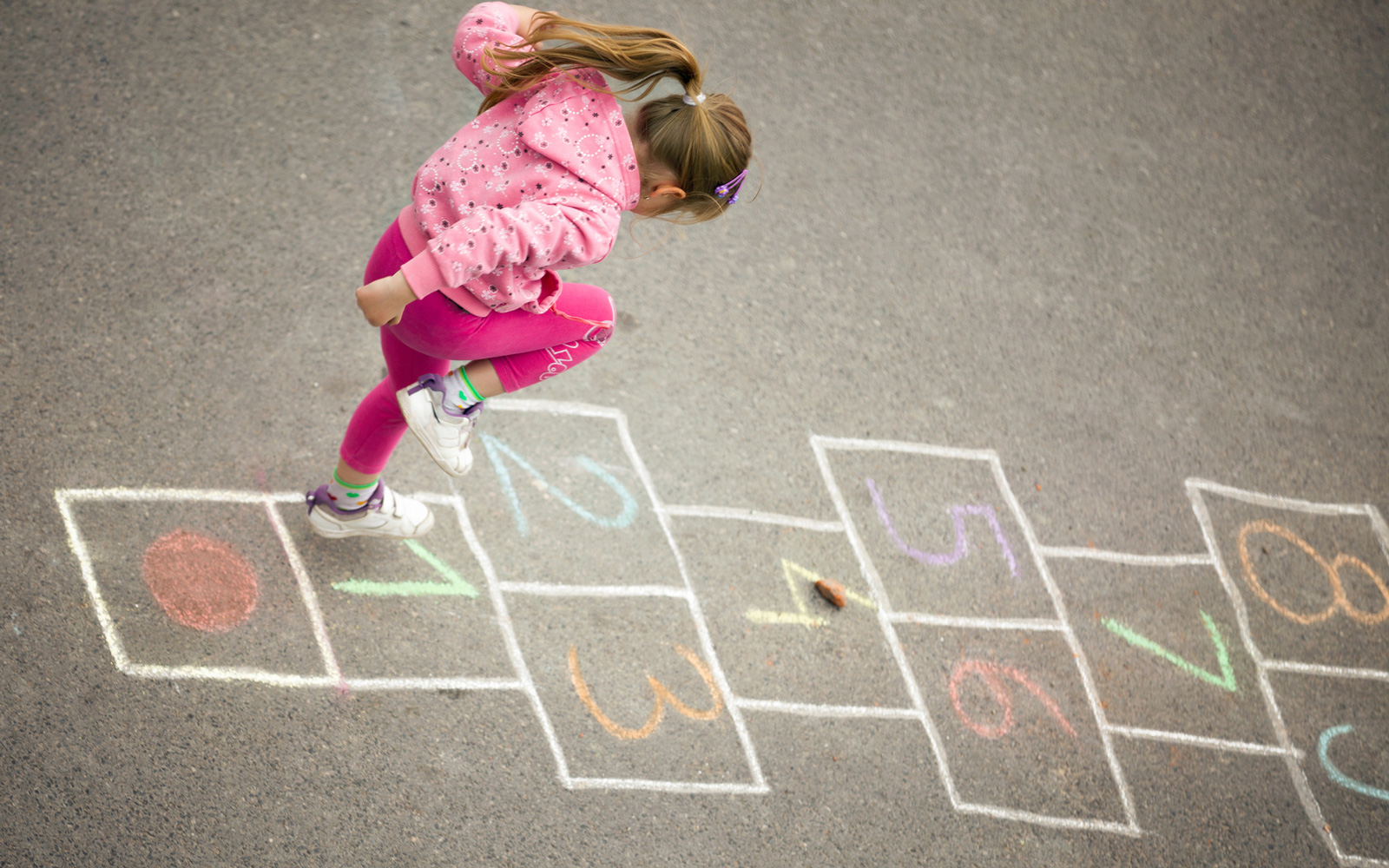 Kid Plays Hopscotch Outdoors