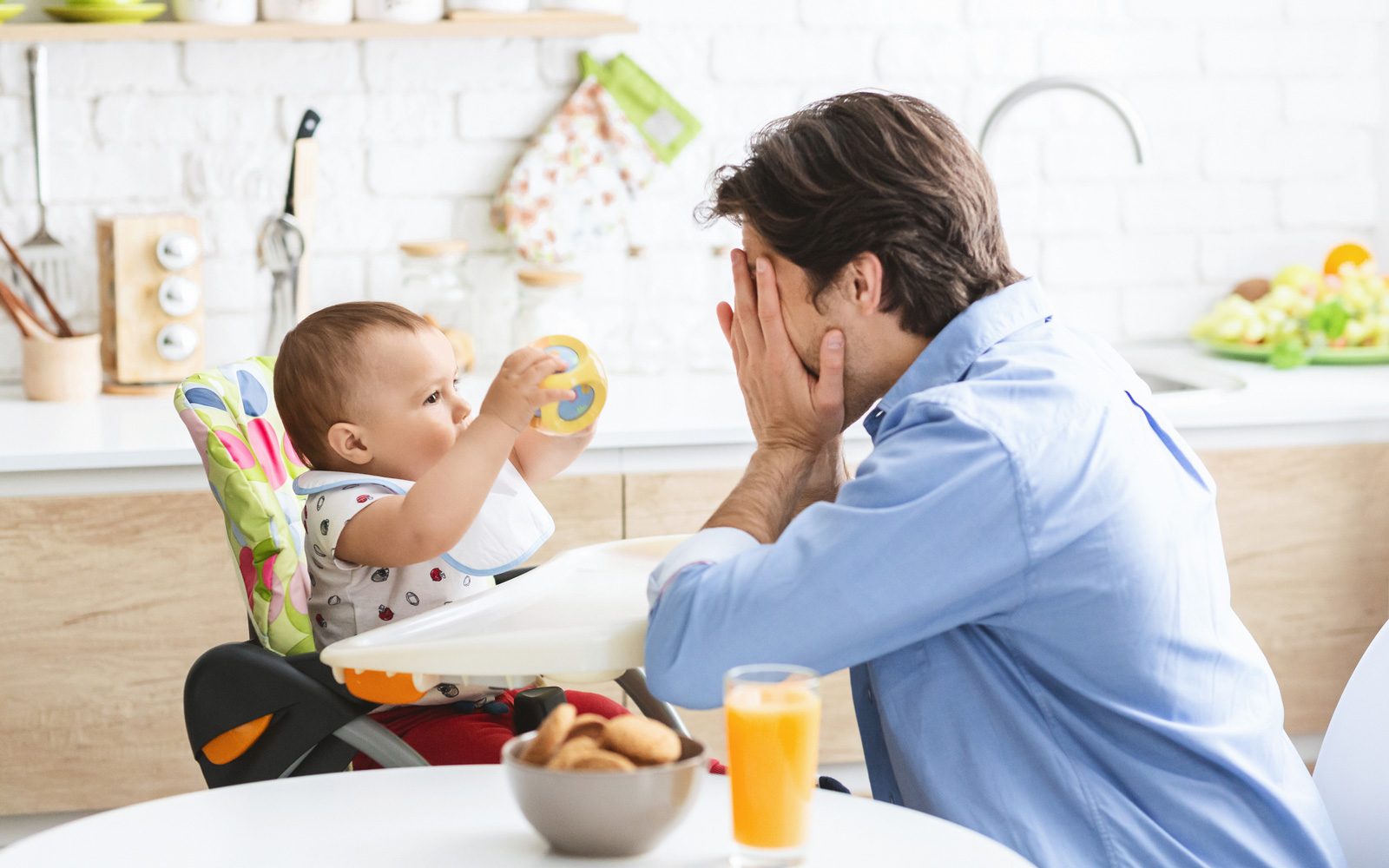 Dad Plays Peek-a-Boo with Baby