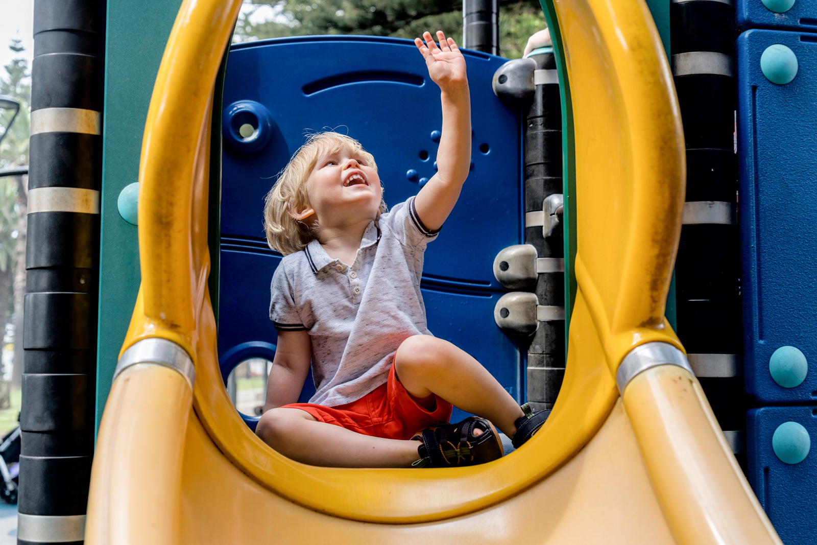Child plays on structure in park